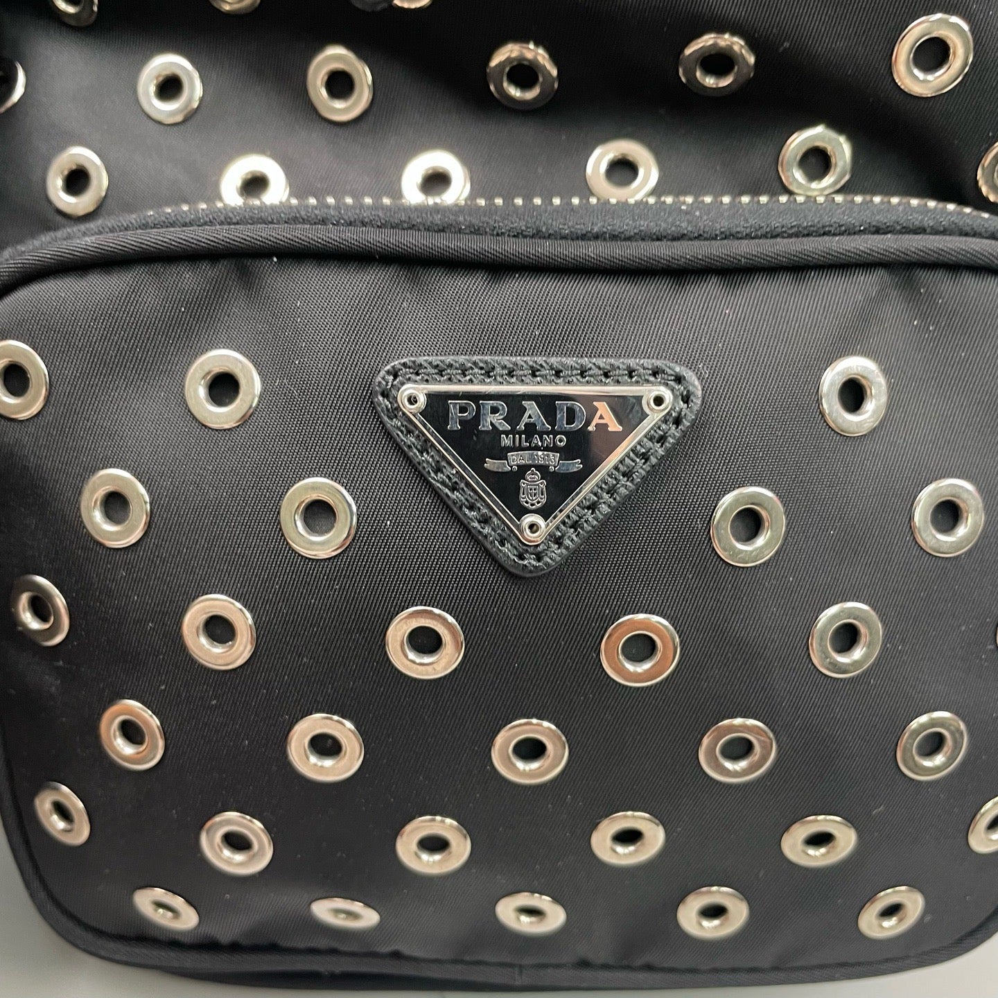Prada - Grommet Embellished Drawstring Bucket Bag - Nylon fabric with leather trim - Black - (small)