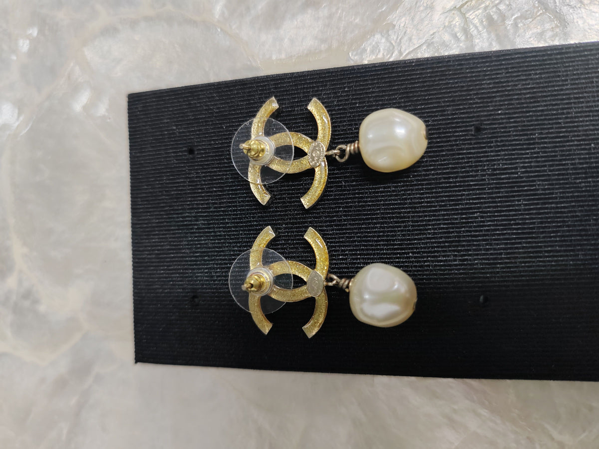 Chanel - Other - Gold-tone base metal with imitation pearls and clear and black rhinestone-style stones. - Multicolour