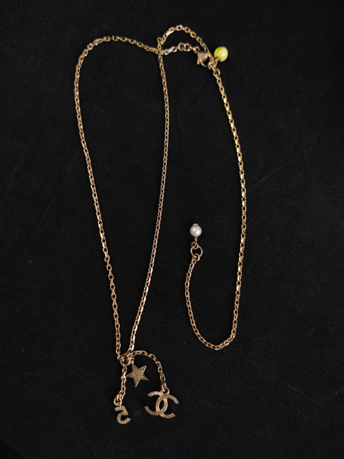 Chanel - Other - Gold-tone base metal with rhinestone-set charms and pearl-like bead accents. - Gold