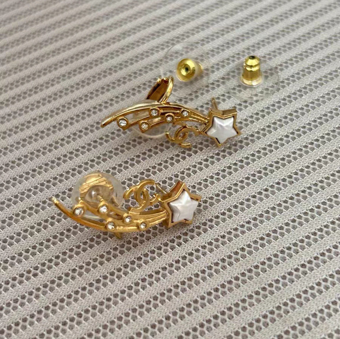 Chanel - Other - Gold-tone metal with clear crystal-like accents and white star-shaped inlays; exact composition unknown. - Gold
