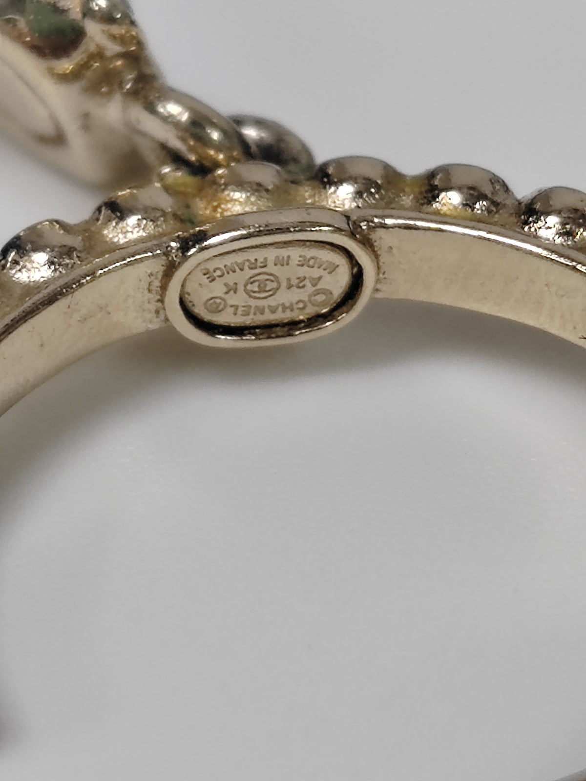 Chanel - Other - Gold-tone metal with clear glass rhinestones, black accents and a faux pearl accent. - Gold