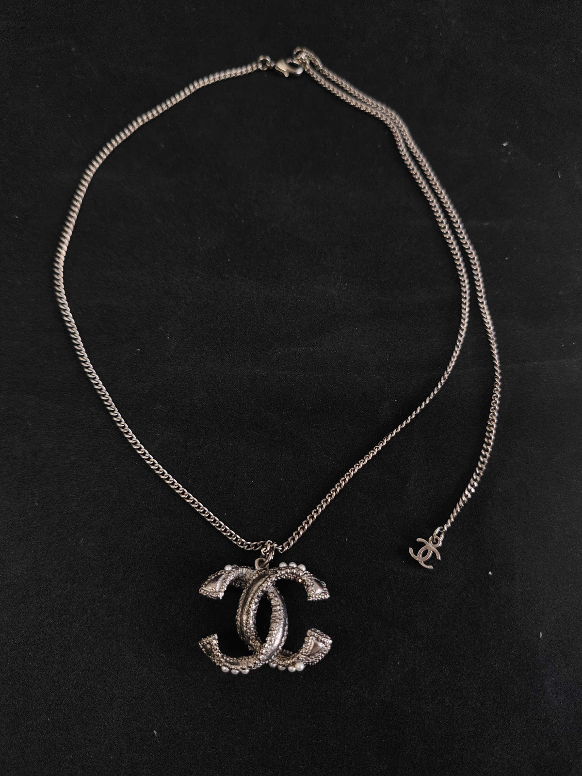 Chanel - Other - Silver-tone base metal with pearl-like and dark decorative accents; exact composition is not confirmed. - Silver
