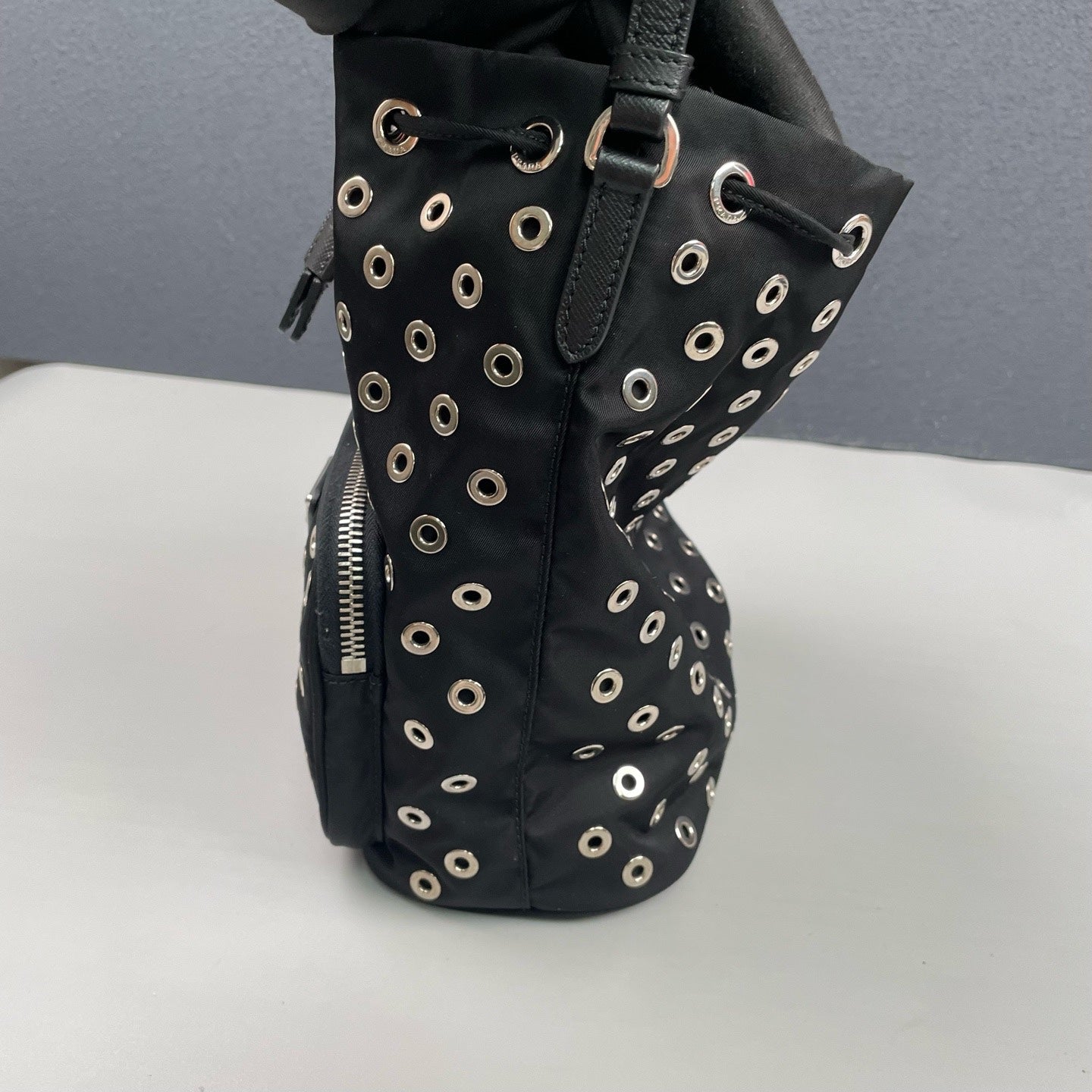 Prada - Grommet Embellished Drawstring Bucket Bag - Nylon fabric with leather trim - Black - (small)