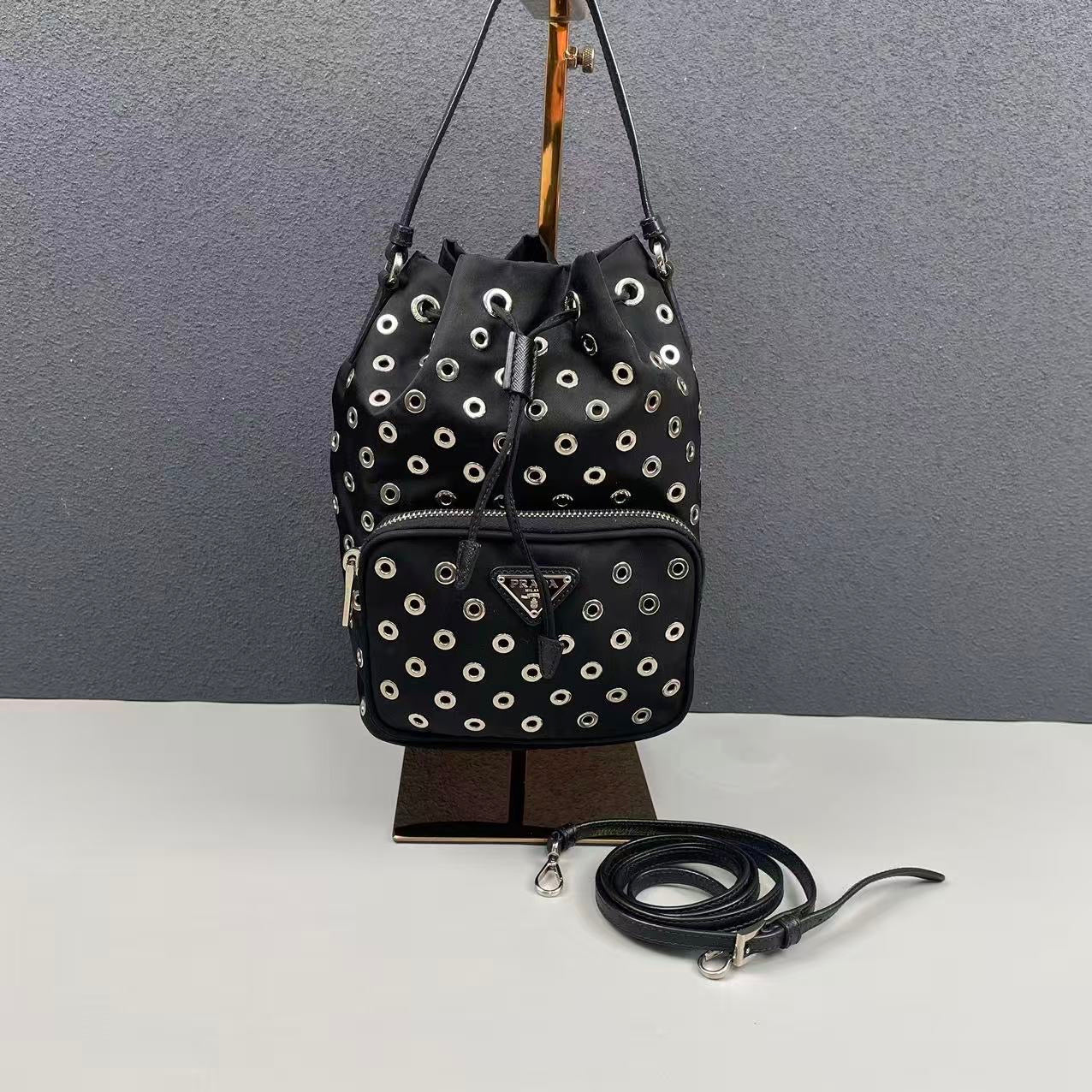 Prada - Grommet Embellished Drawstring Bucket Bag - Nylon fabric with leather trim - Black - (small)