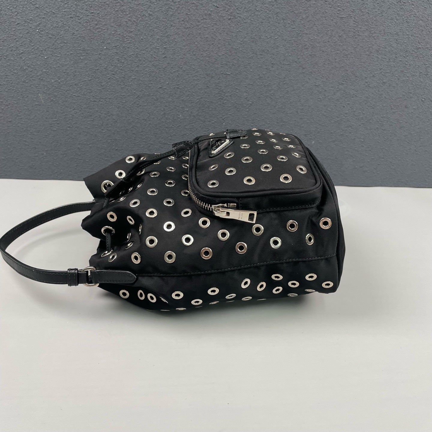 Prada - Grommet Embellished Drawstring Bucket Bag - Nylon fabric with leather trim - Black - (small)