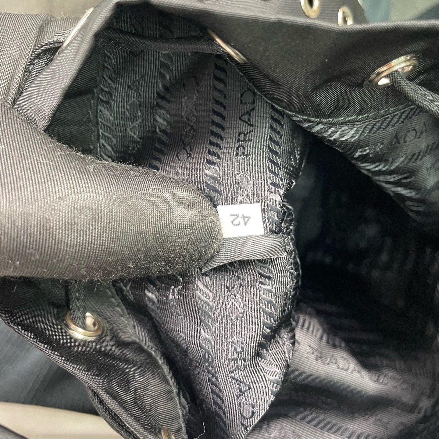 Prada - Grommet Embellished Drawstring Bucket Bag - Nylon fabric with leather trim - Black - (small)