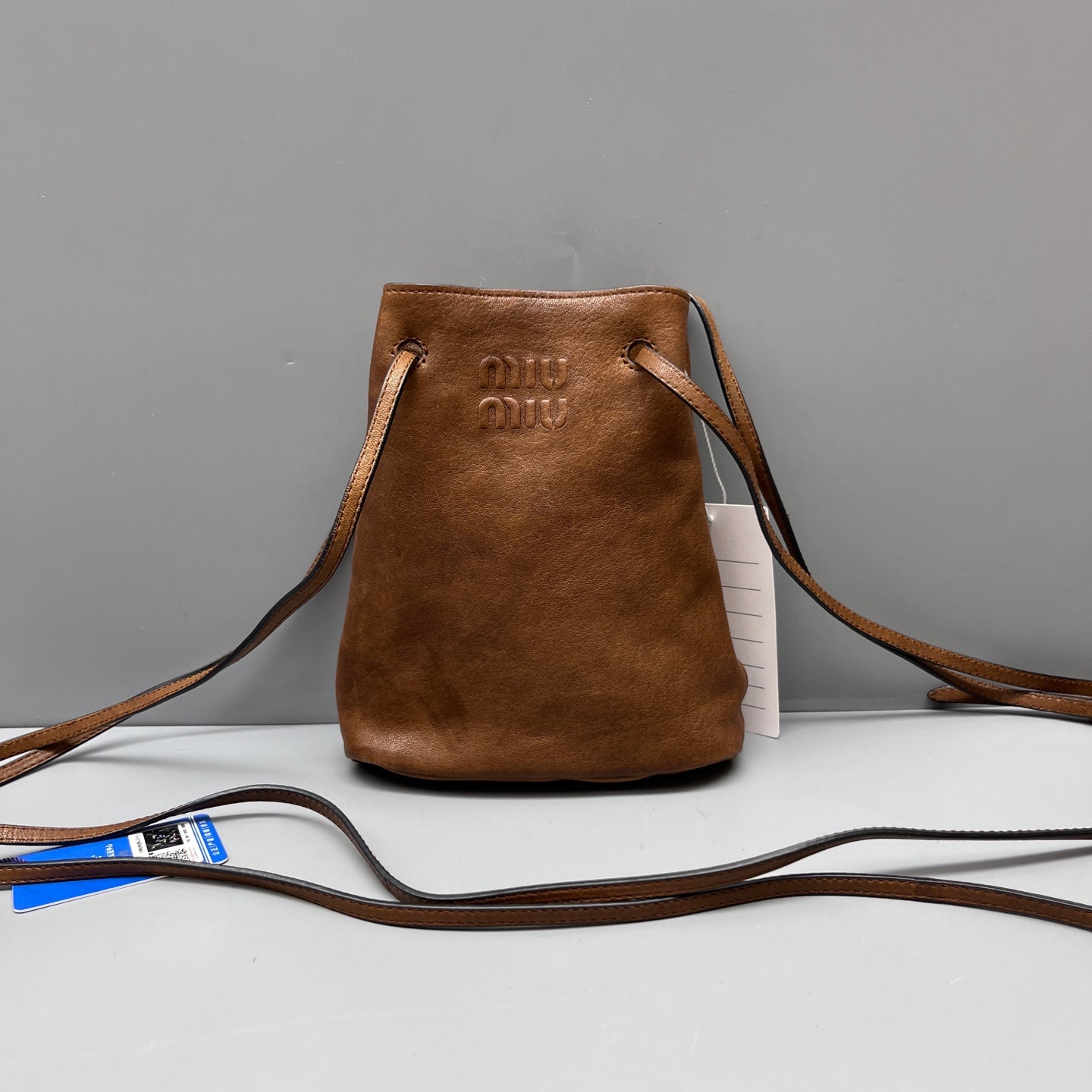 Miu Miu - Drawstring Mini Bucket Bag - Grained leather - Brown - (mini)