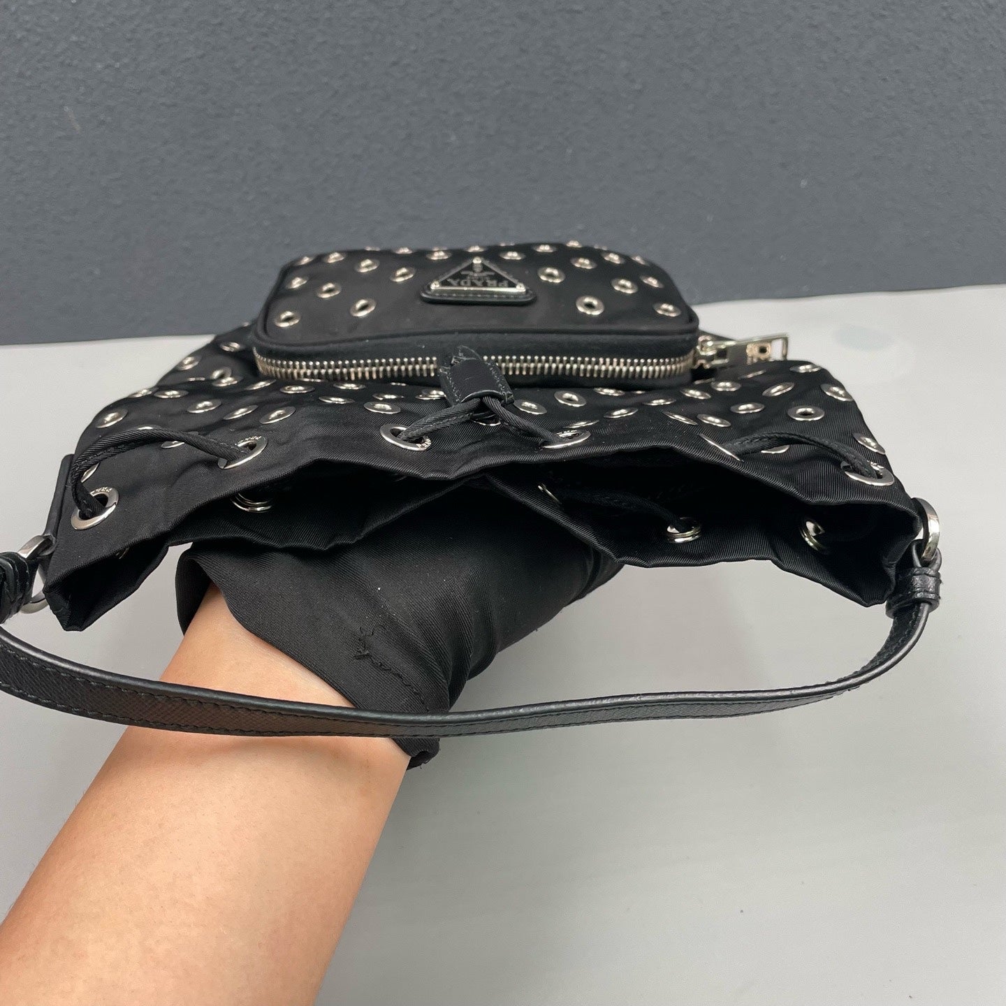 Prada - Grommet Embellished Drawstring Bucket Bag - Nylon fabric with leather trim - Black - (small)