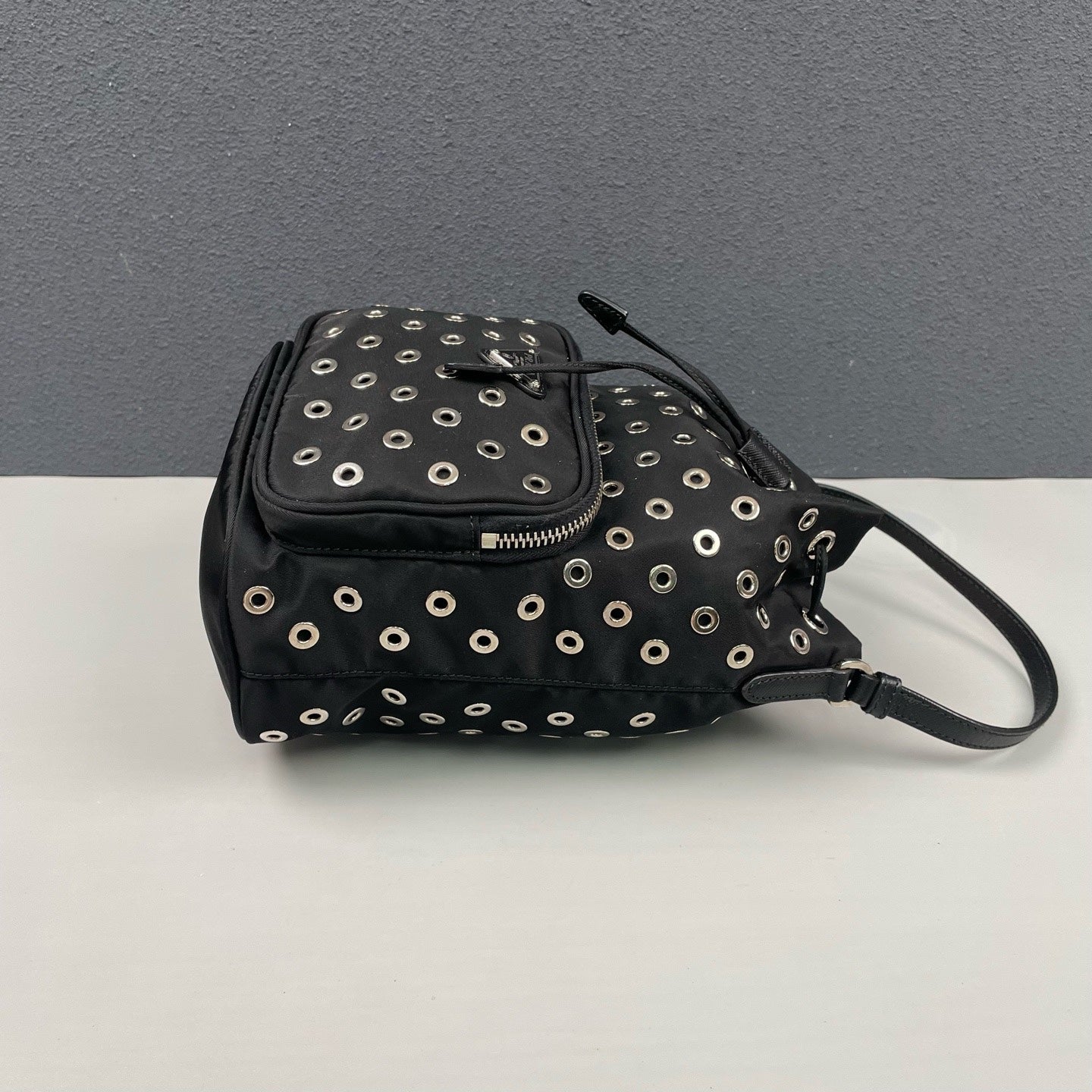 Prada - Grommet Embellished Drawstring Bucket Bag - Nylon fabric with leather trim - Black - (small)
