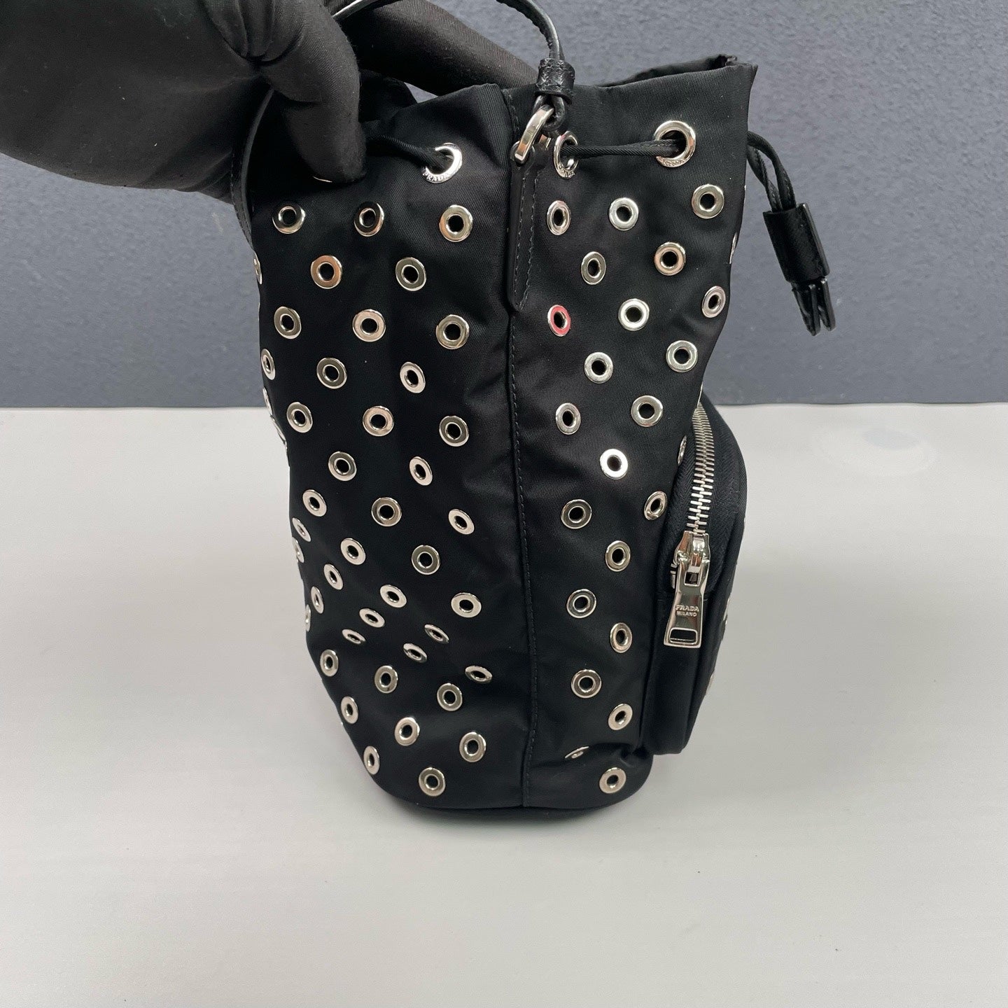 Prada - Grommet Embellished Drawstring Bucket Bag - Nylon fabric with leather trim - Black - (small)