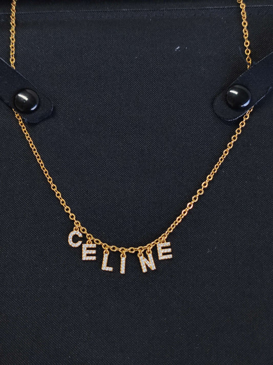 Celine - Other - Gold-tone metal chain and letter charms with clear rhinestone embellishments. - Gold