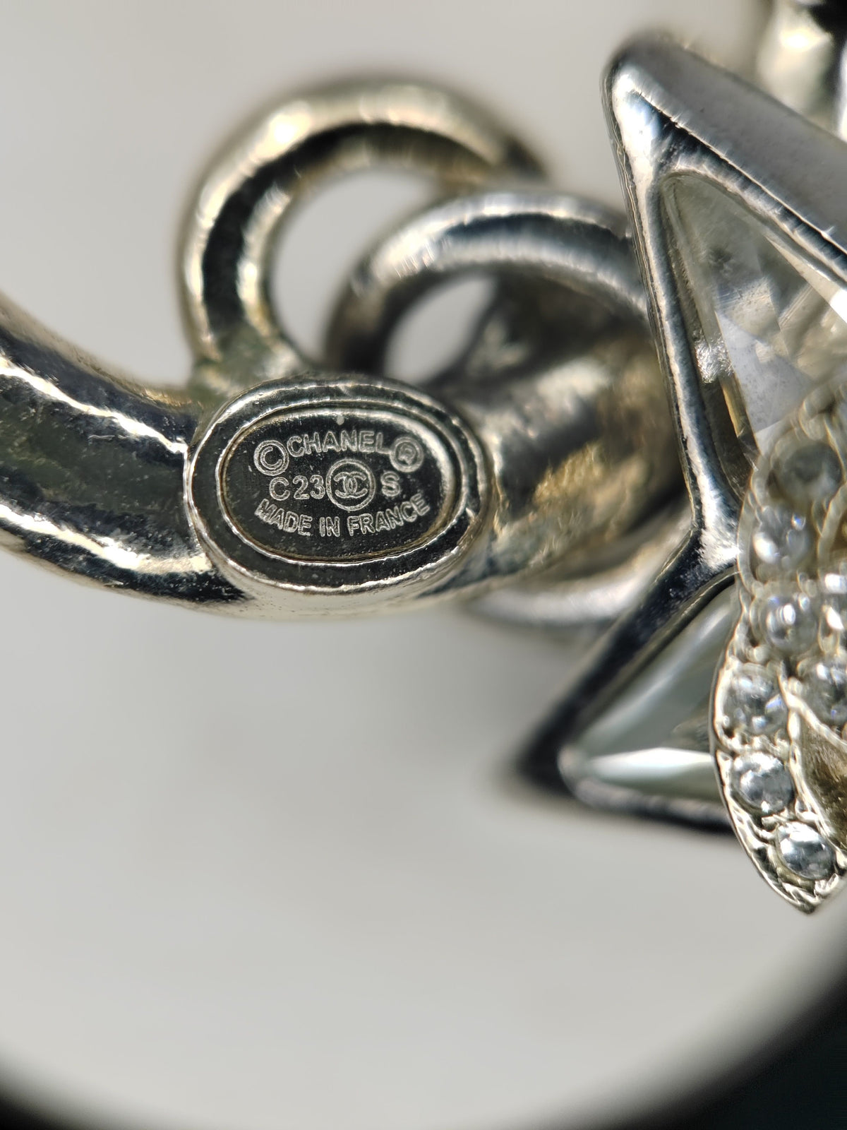 Chanel - Other - Base metal with gold-tone and silver-tone finishes and clear rhinestone embellishments. - Multicolour