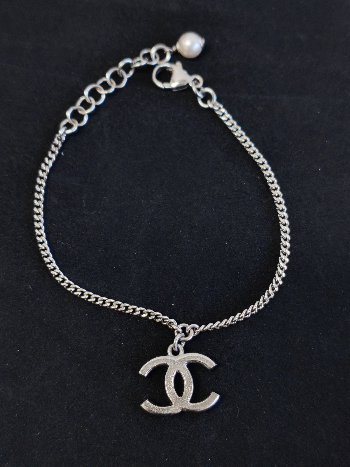 Chanel - Other - Costume-jewelry metal with clear crystal-like stones and a pearl-style bead. - Silver