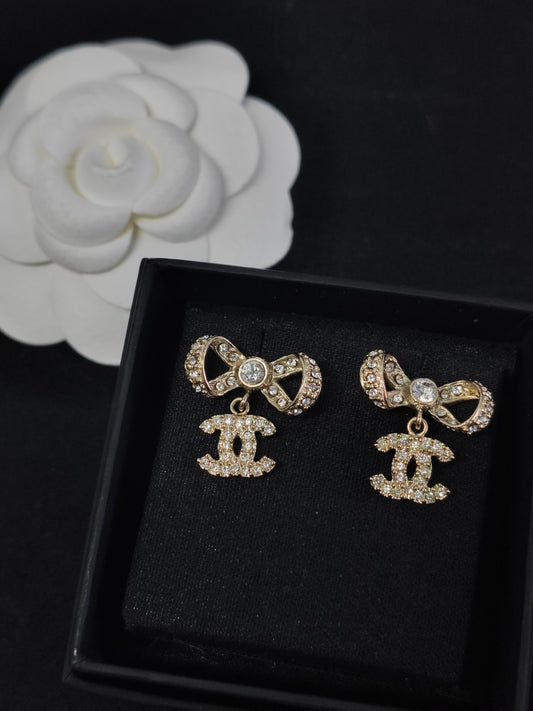 Chanel - Other - Gold-tone base metal with clear rhinestone embellishments; exact alloy and stone composition are unconfirmed. - Gold
