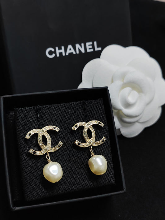 Chanel - Other - Gold-tone base metal with imitation pearls and clear and black rhinestone-style stones. - Multicolour
