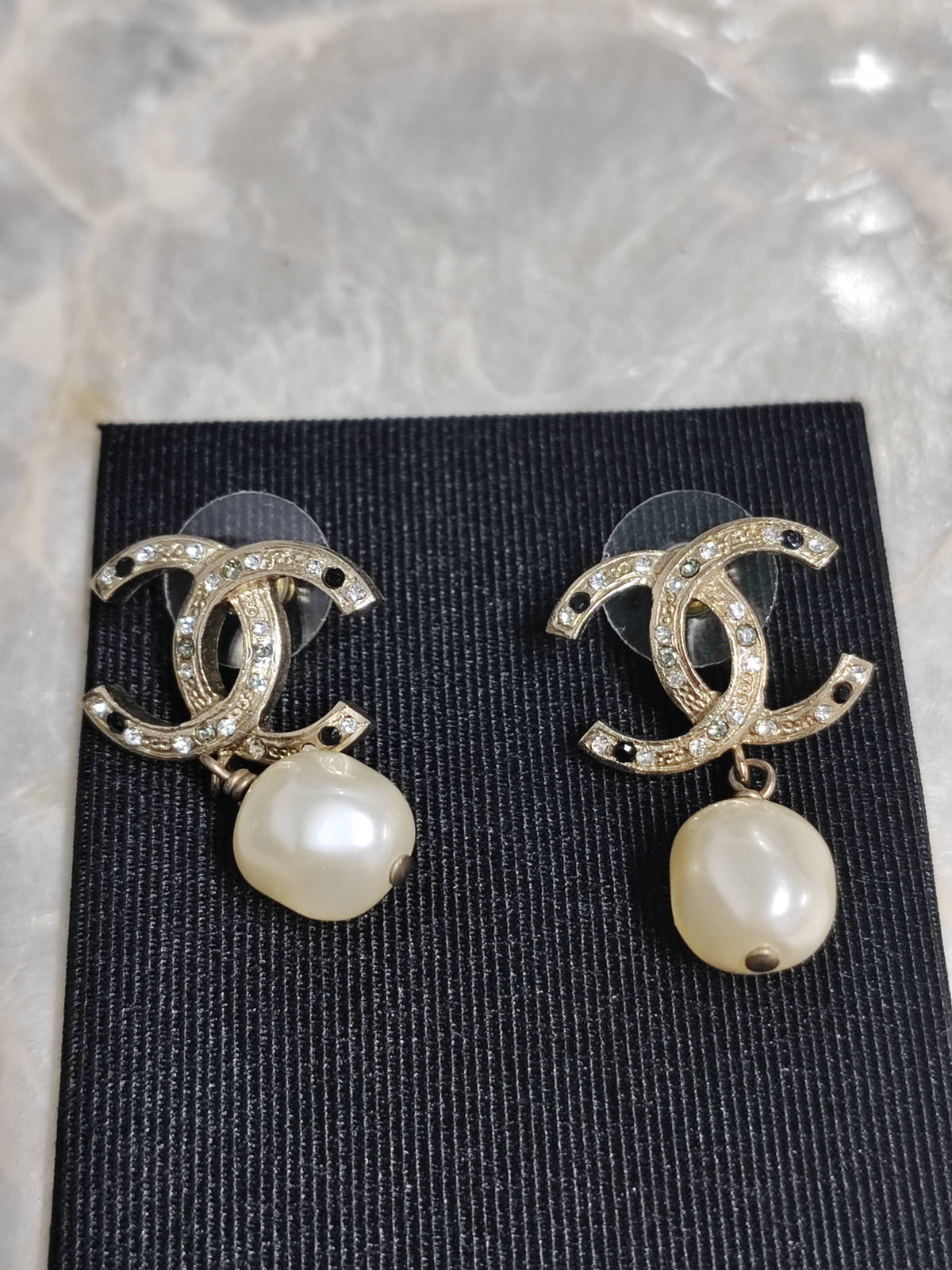 Chanel - Other - Gold-tone base metal with imitation pearls and clear and black rhinestone-style stones. - Multicolour