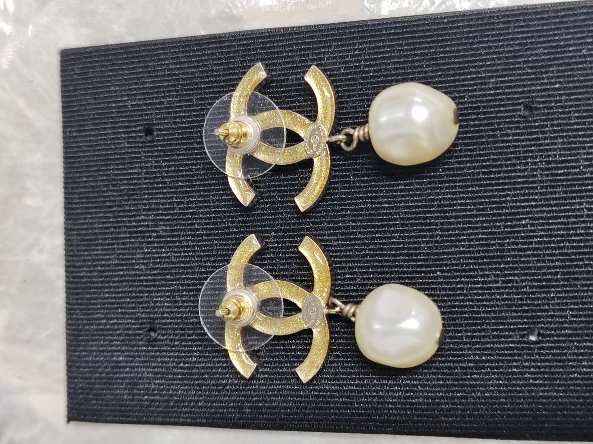 Chanel - Other - Gold-tone base metal with imitation pearls and clear and black rhinestone-style stones. - Multicolour