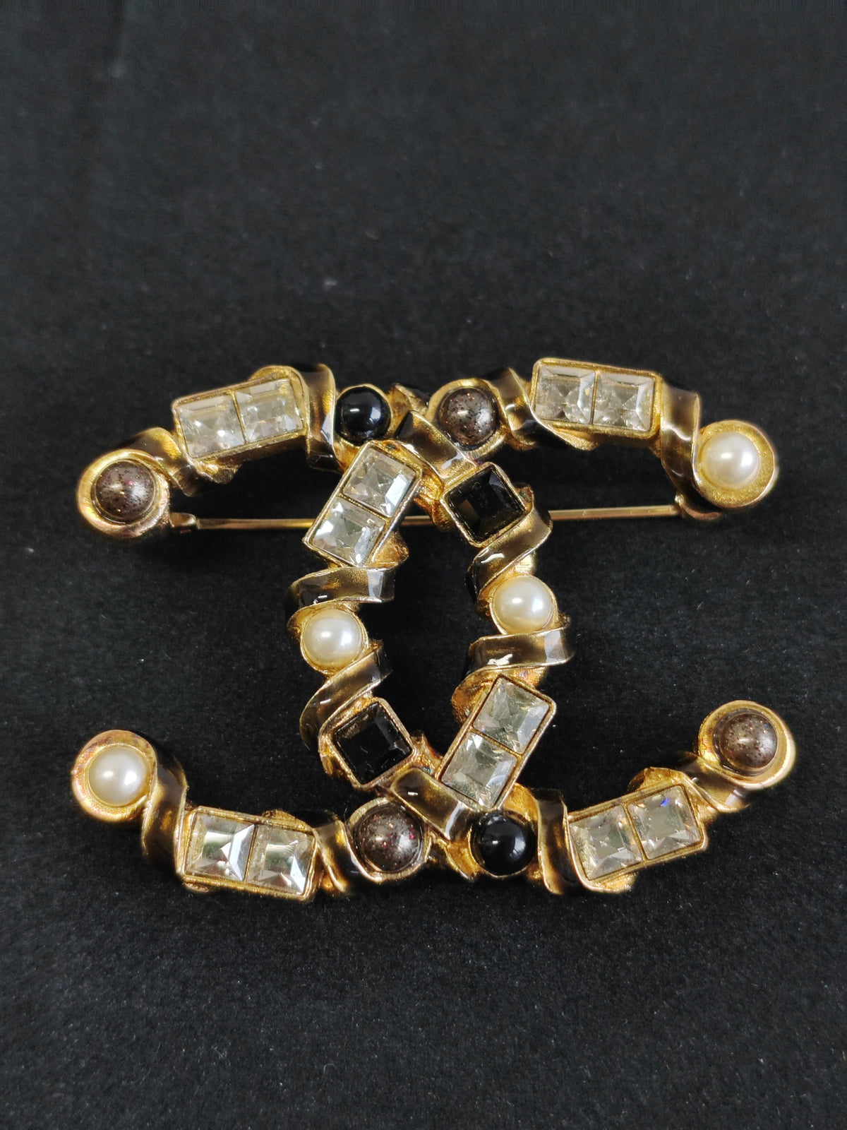 Chanel - Other - Gold-tone base metal with pearl, clear rhinestone or crystal, and black stone-like accents; exact stone and pearl composition is unspecified. - Multicolour