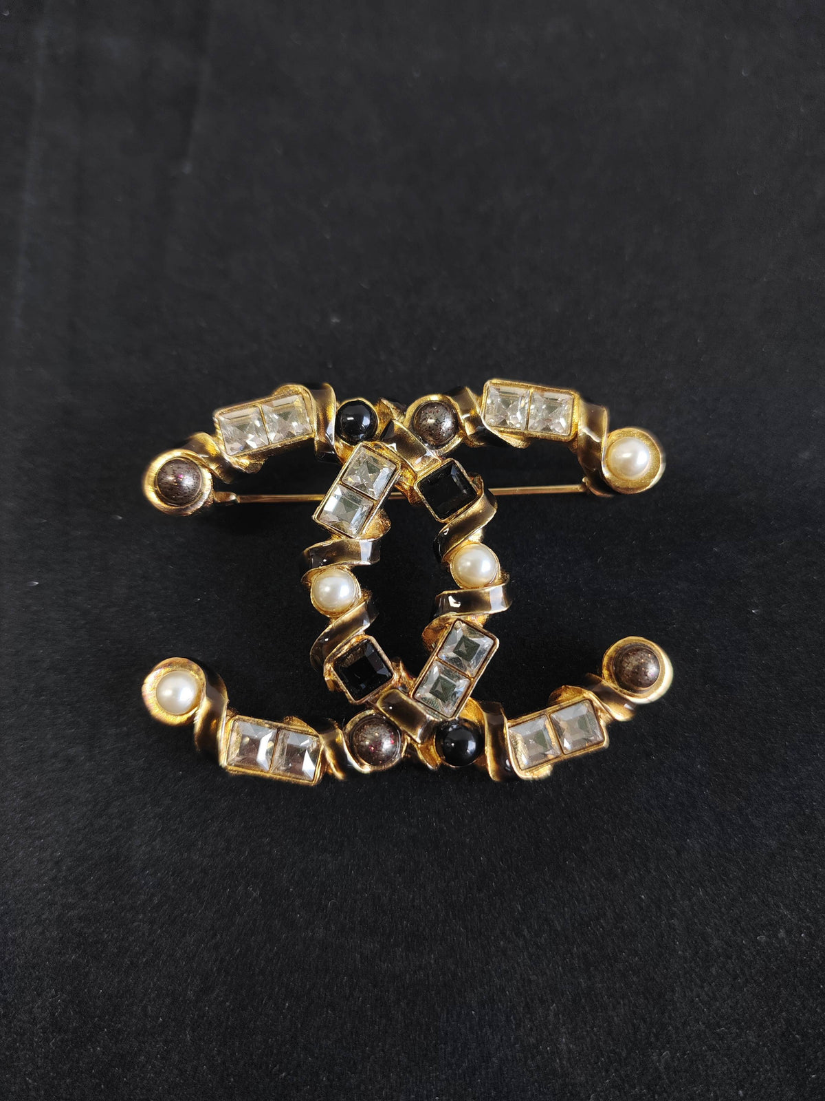 Chanel - Other - Gold-tone base metal with pearl, clear rhinestone or crystal, and black stone-like accents; exact stone and pearl composition is unspecified. - Multicolour