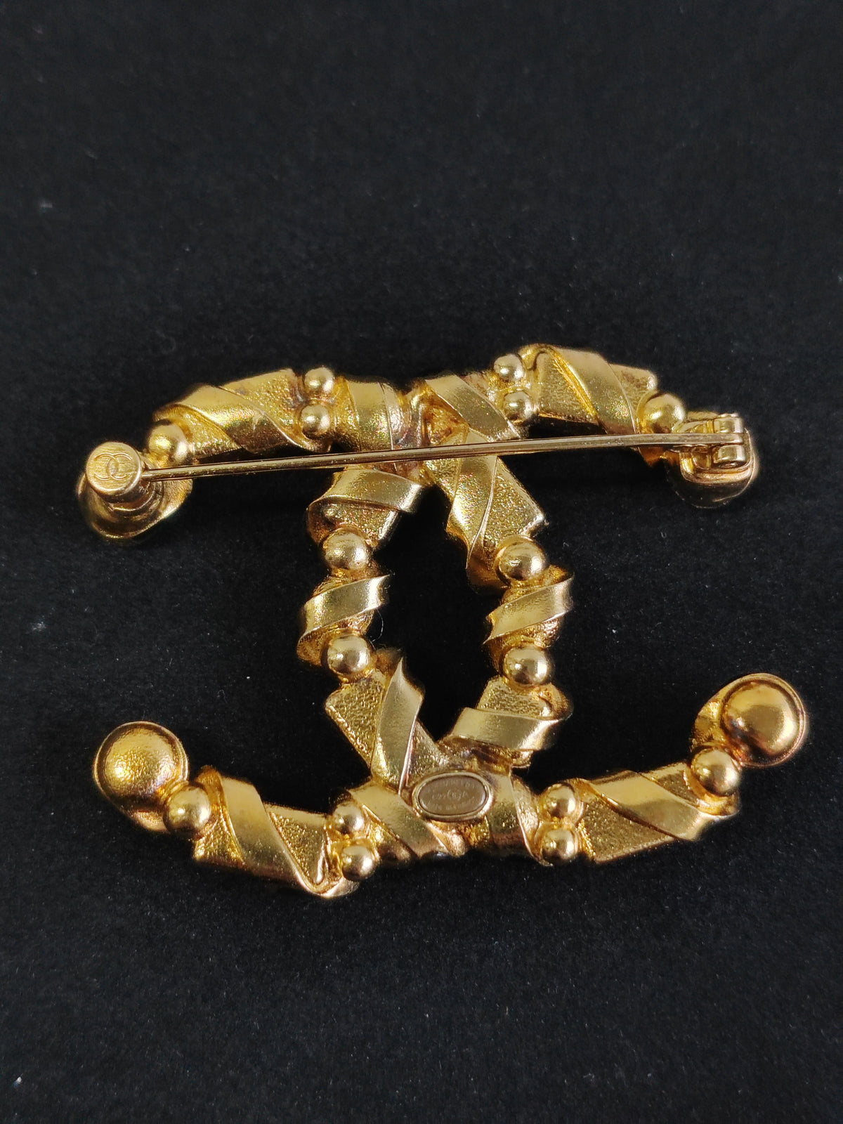 Chanel - Other - Gold-tone base metal with pearl, clear rhinestone or crystal, and black stone-like accents; exact stone and pearl composition is unspecified. - Multicolour