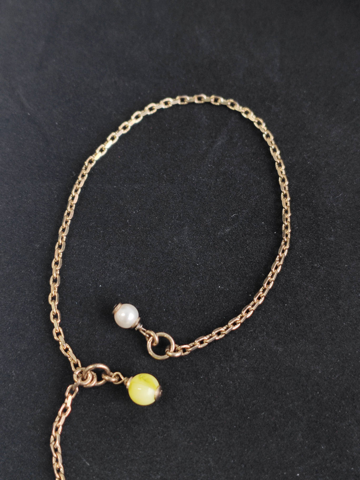 Chanel - Other - Gold-tone base metal with rhinestone-set charms and pearl-like bead accents. - Gold