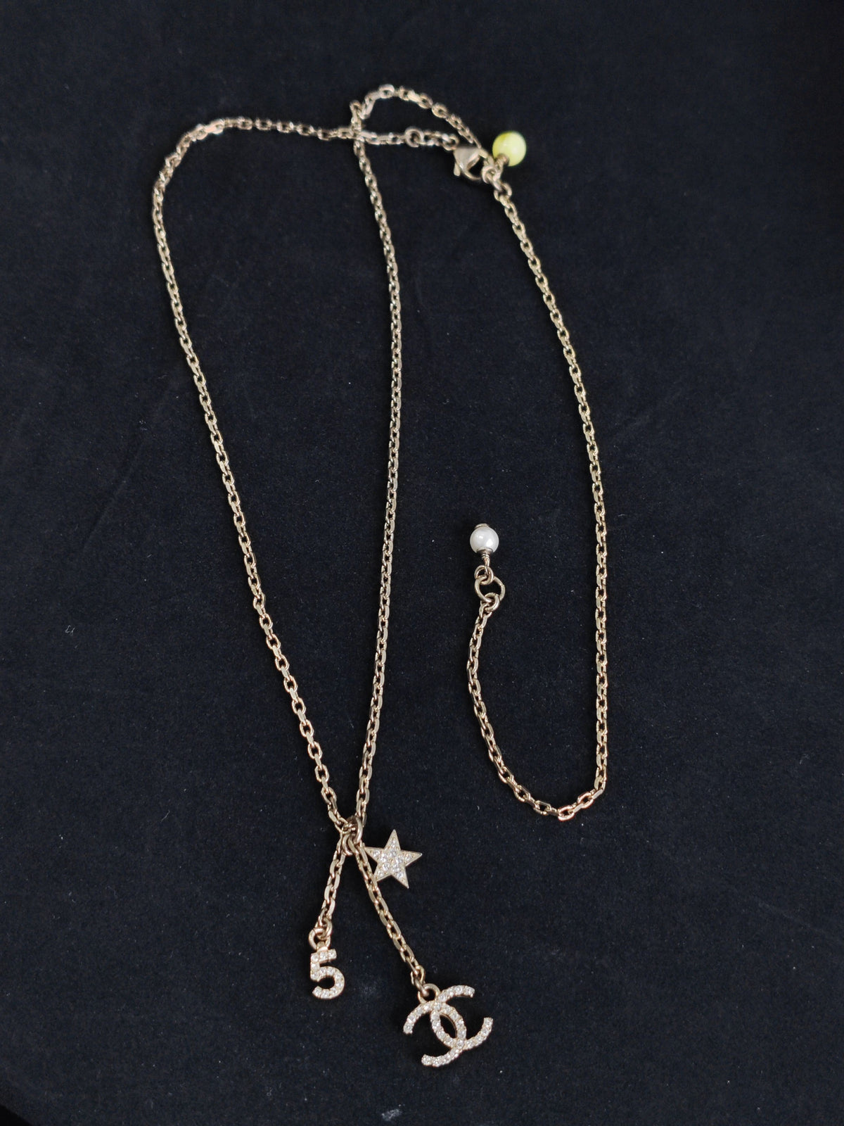 Chanel - Other - Gold-tone base metal with rhinestone-set charms and pearl-like bead accents. - Gold