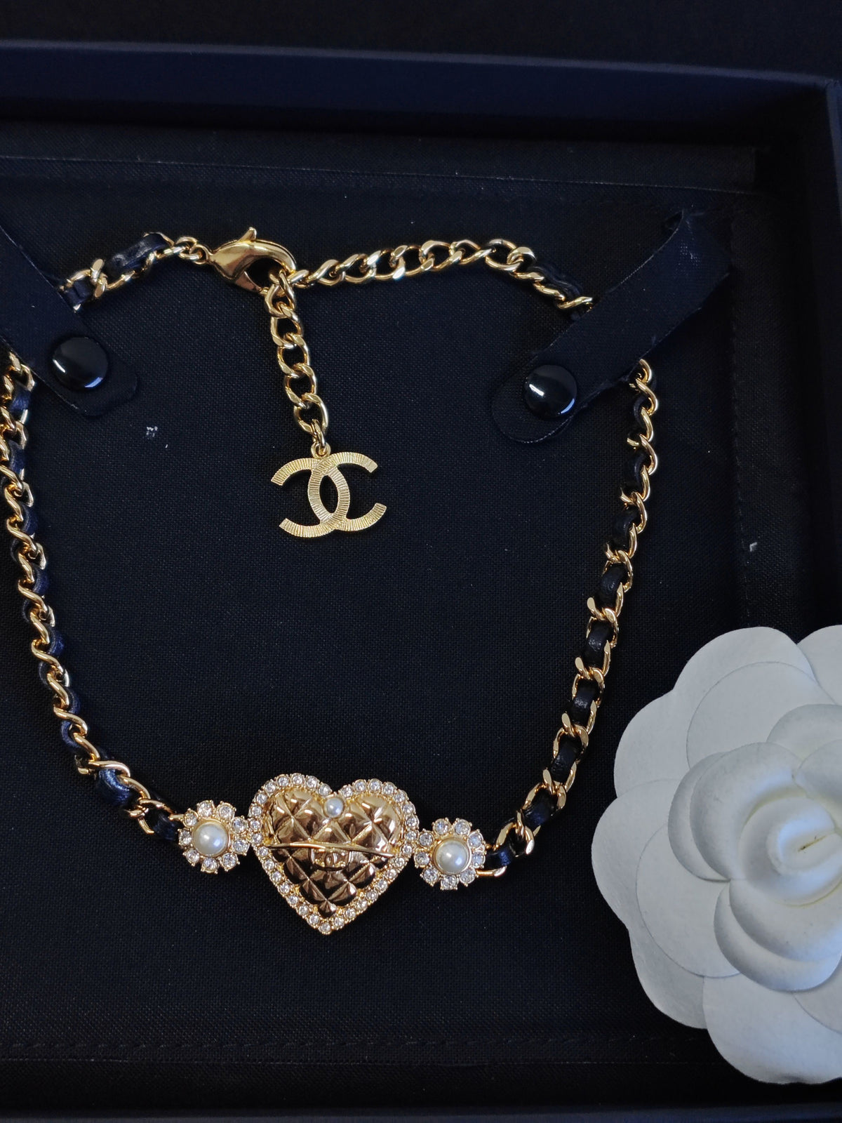 Chanel - Other - Gold-tone base metal with rhinestones and pearl accents; black leather woven through the chain. - Gold