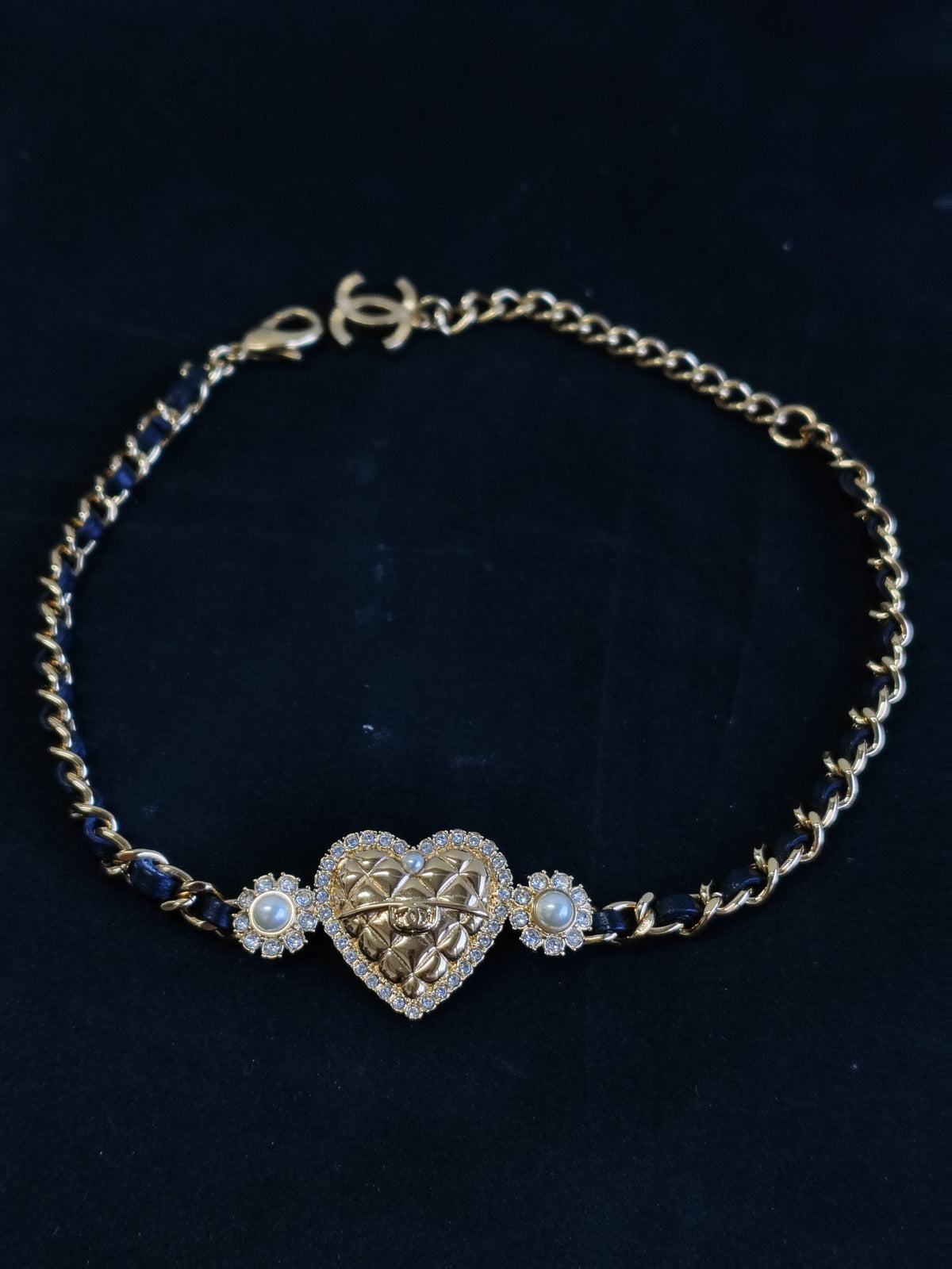 Chanel - Other - Gold-tone base metal with rhinestones and pearl accents; black leather woven through the chain. - Gold