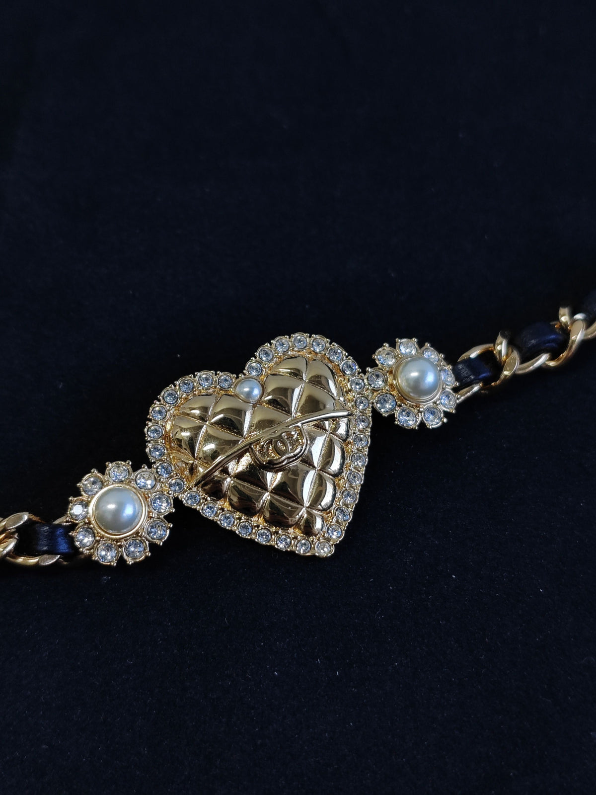 Chanel - Other - Gold-tone base metal with rhinestones and pearl accents; black leather woven through the chain. - Gold