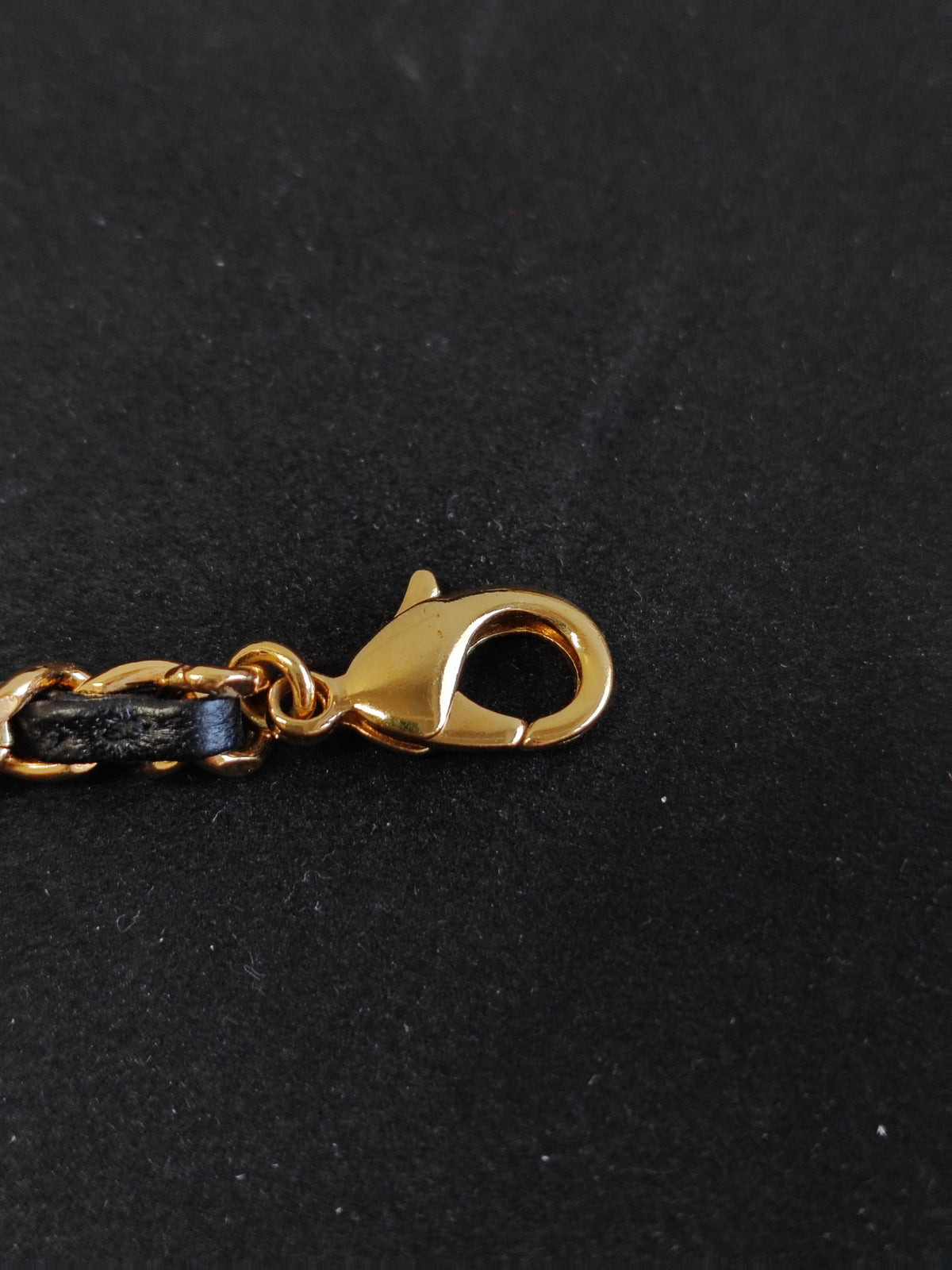 Chanel - Other - Gold-tone base metal with rhinestones and pearl accents; black leather woven through the chain. - Gold