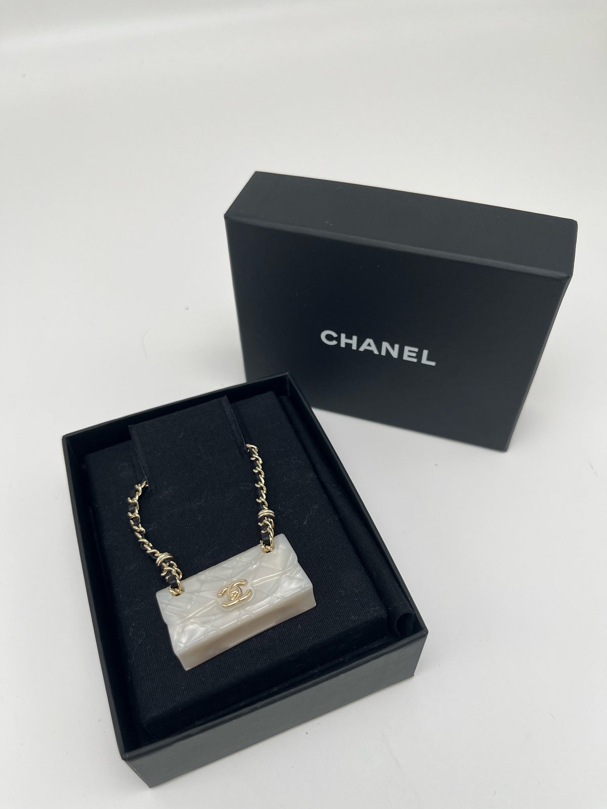 Chanel - Other - Gold-tone metal chain and hardware with a pearlescent white resin pendant. - White - (One size)