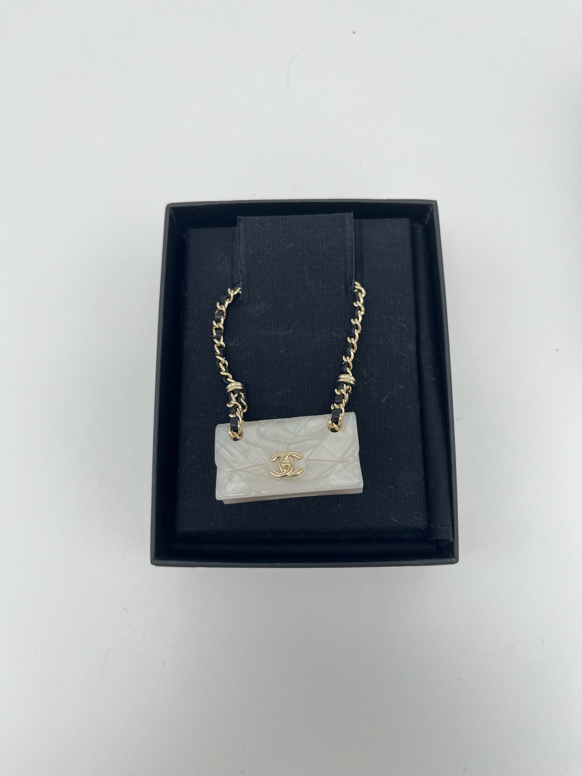 Chanel - Other - Gold-tone metal chain and hardware with a pearlescent white resin pendant. - White - (One size)