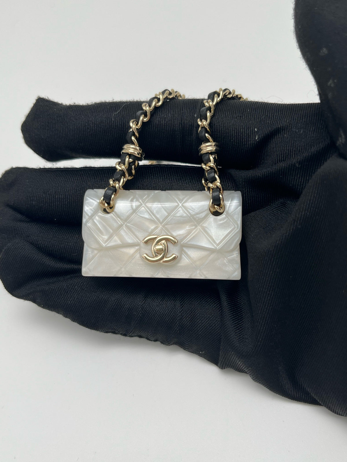 Chanel - Other - Gold-tone metal chain and hardware with a pearlescent white resin pendant. - White - (One size)