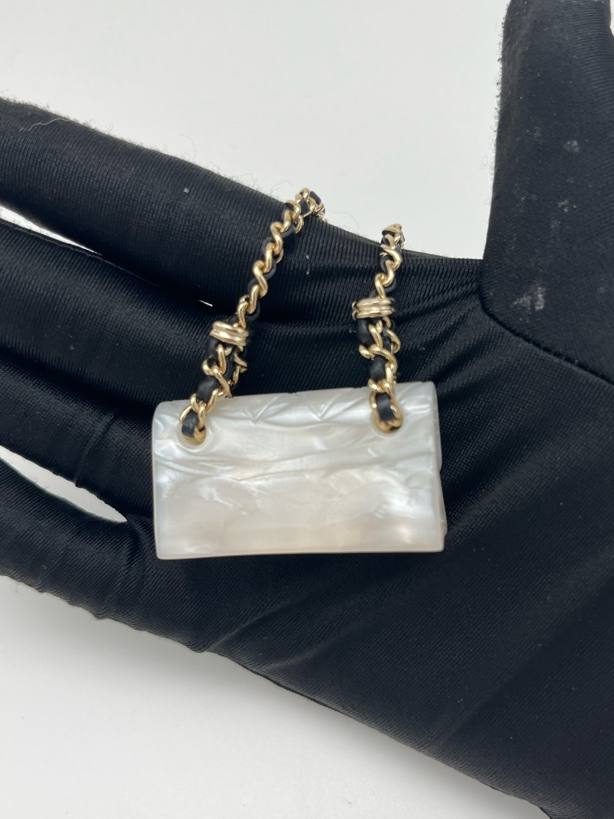 Chanel - Other - Gold-tone metal chain and hardware with a pearlescent white resin pendant. - White - (One size)