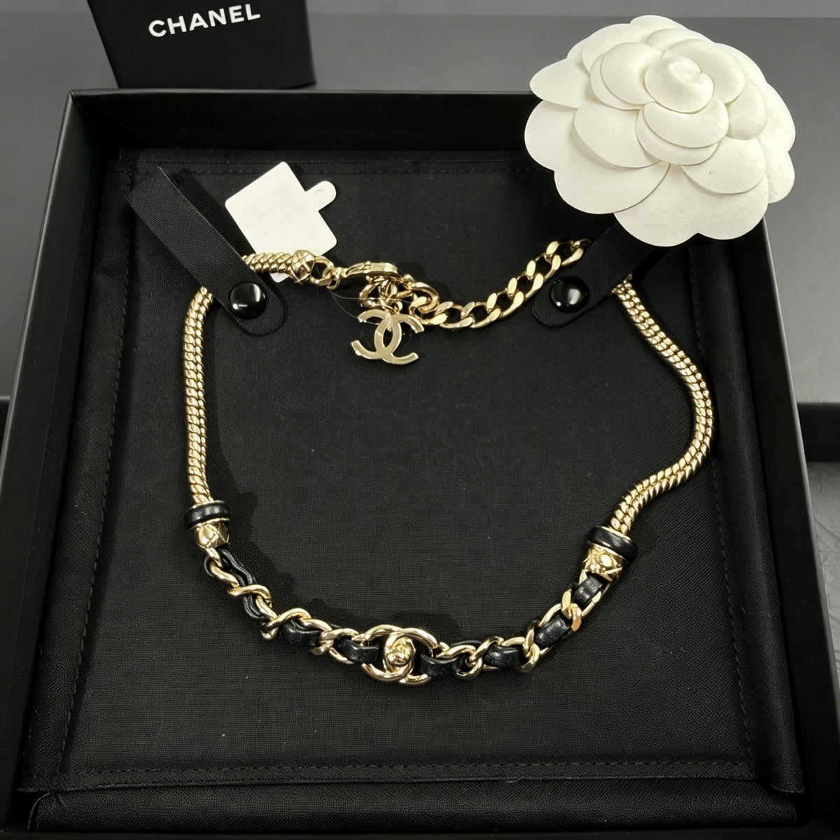 Chanel - Other - Gold-tone metal chain with black leather woven through sections; metal composition unspecified. - Multicolour