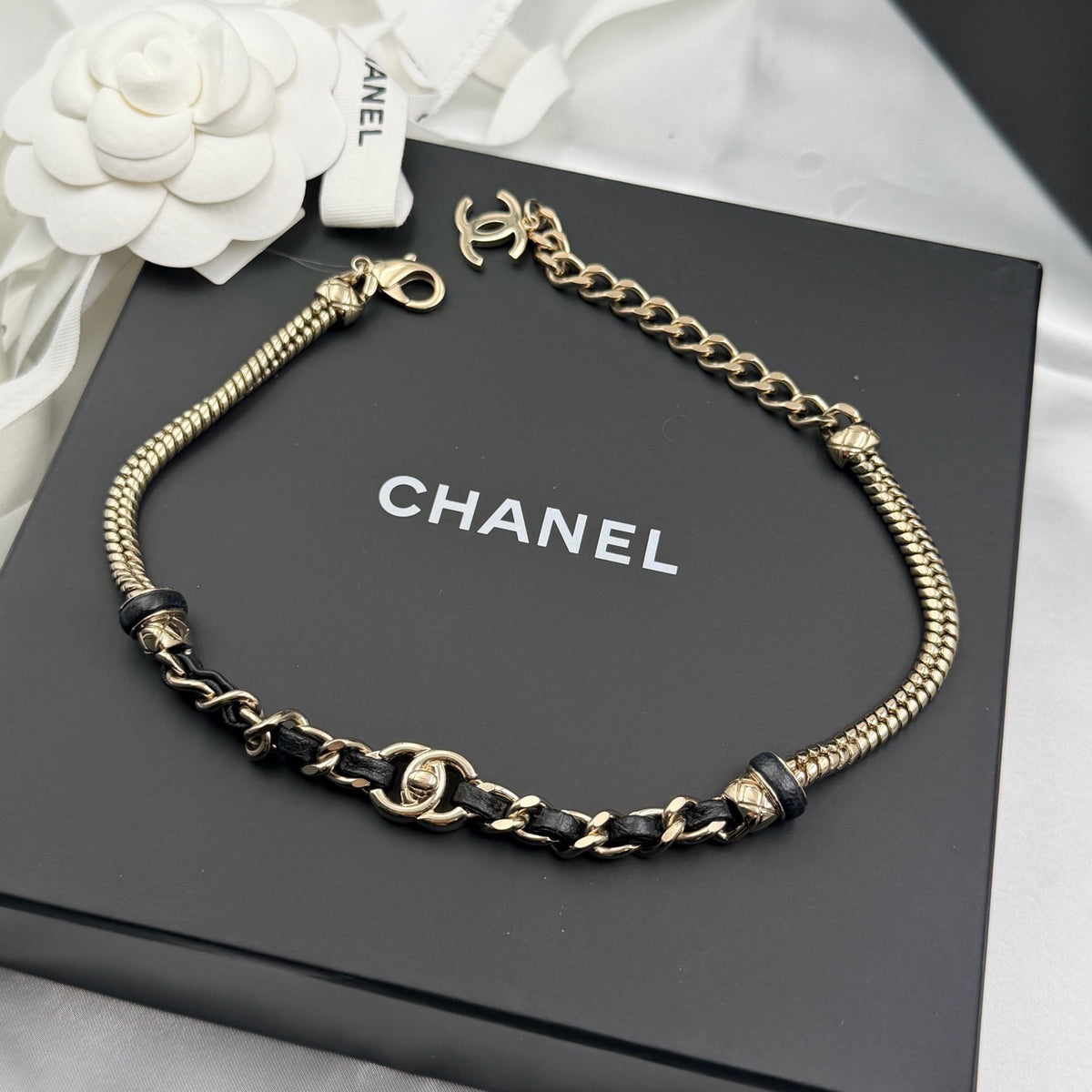Chanel - Other - Gold-tone metal chain with black leather woven through sections; metal composition unspecified. - Multicolour