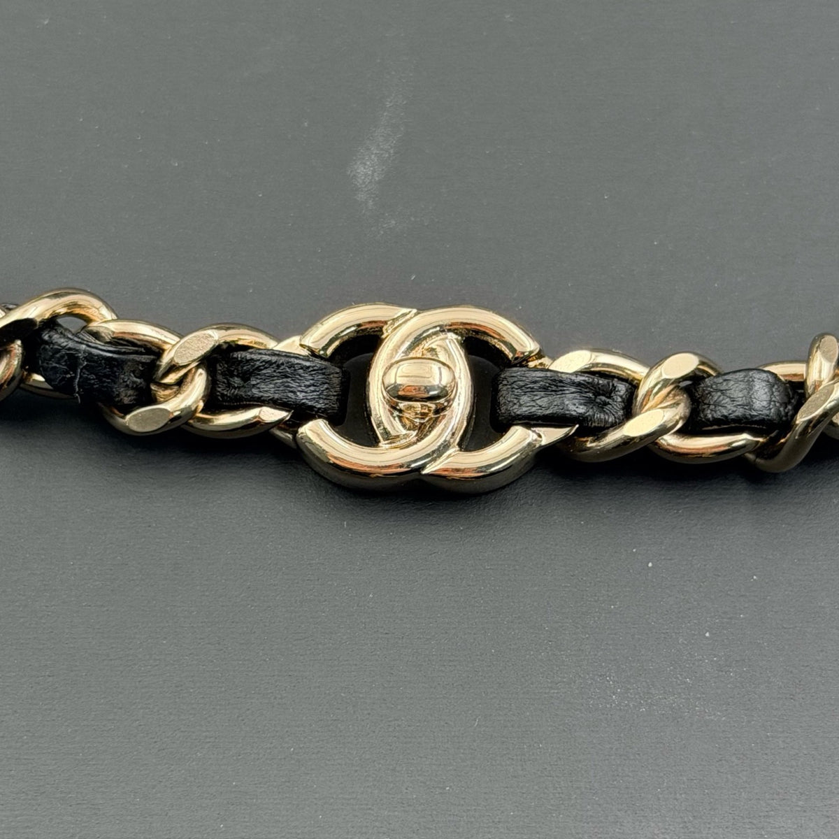 Chanel - Other - Gold-tone metal chain with black leather woven through sections; metal composition unspecified. - Multicolour