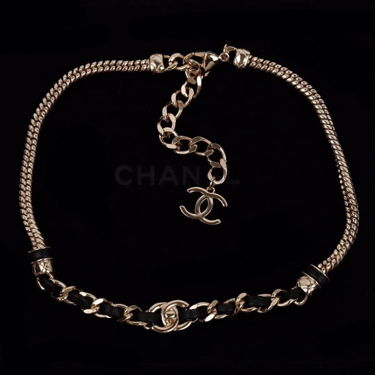 Chanel - Other - Gold-tone metal chain with black leather woven through sections; metal composition unspecified. - Multicolour