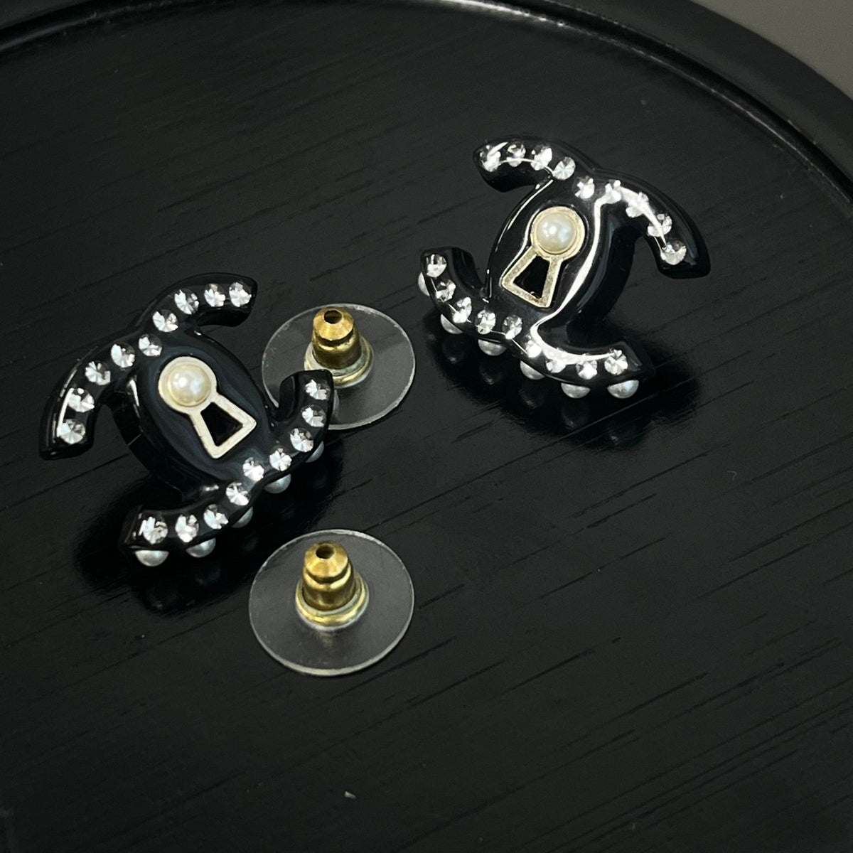 Chanel - Other - Gold-tone metal details with rhinestones, pearl and black resin elements; exact composition not confirmed. - Black