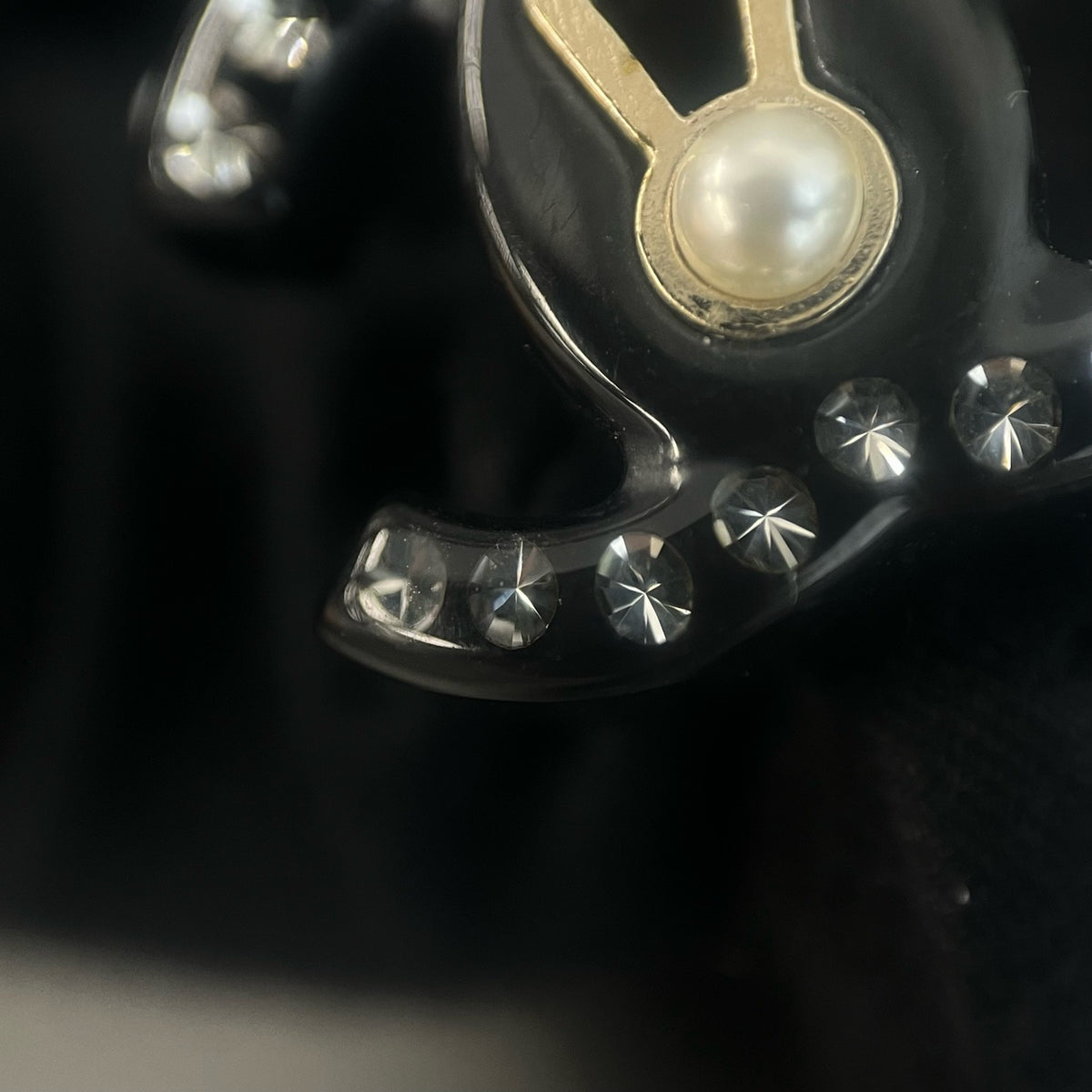 Chanel - Other - Gold-tone metal details with rhinestones, pearl and black resin elements; exact composition not confirmed. - Black