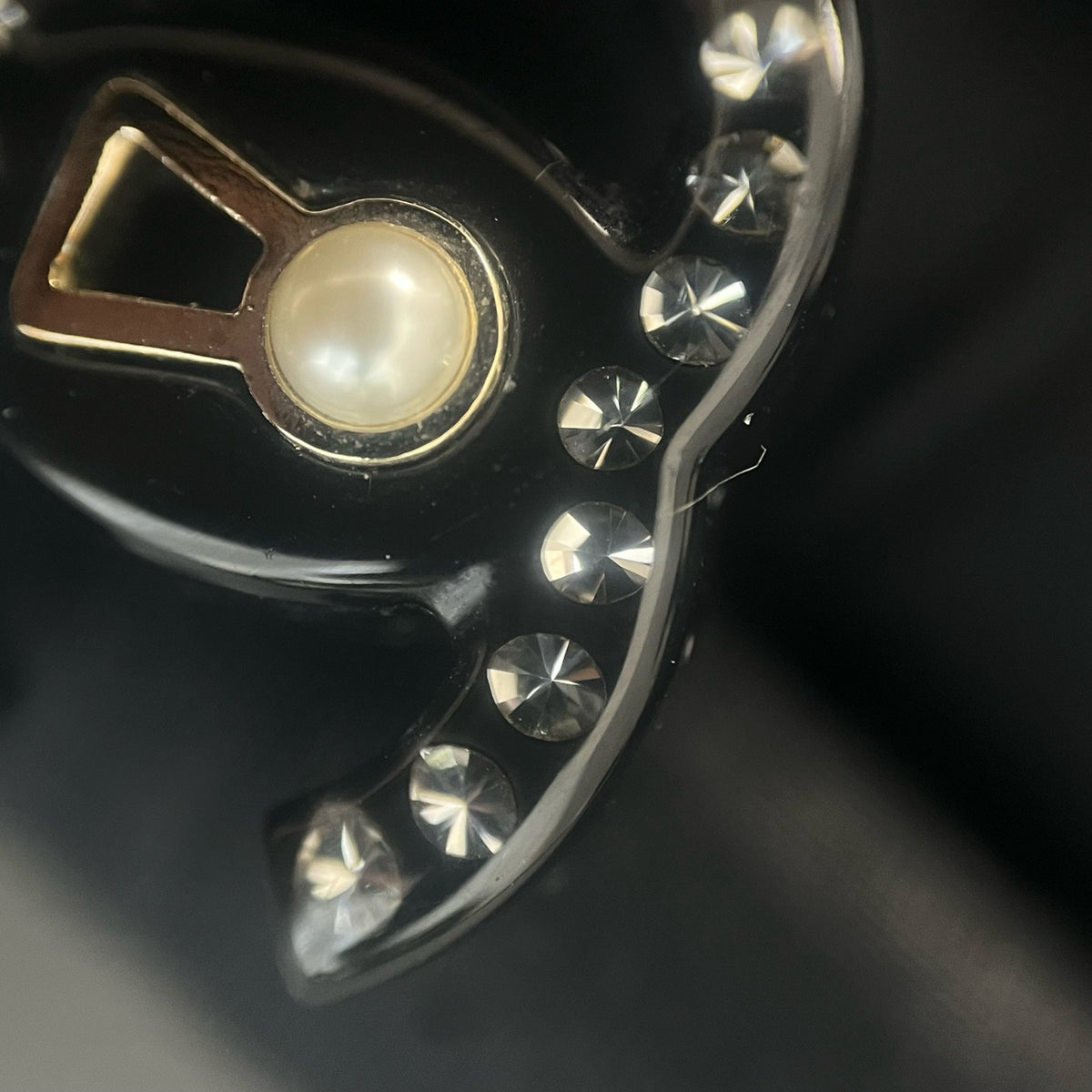 Chanel - Other - Gold-tone metal details with rhinestones, pearl and black resin elements; exact composition not confirmed. - Black