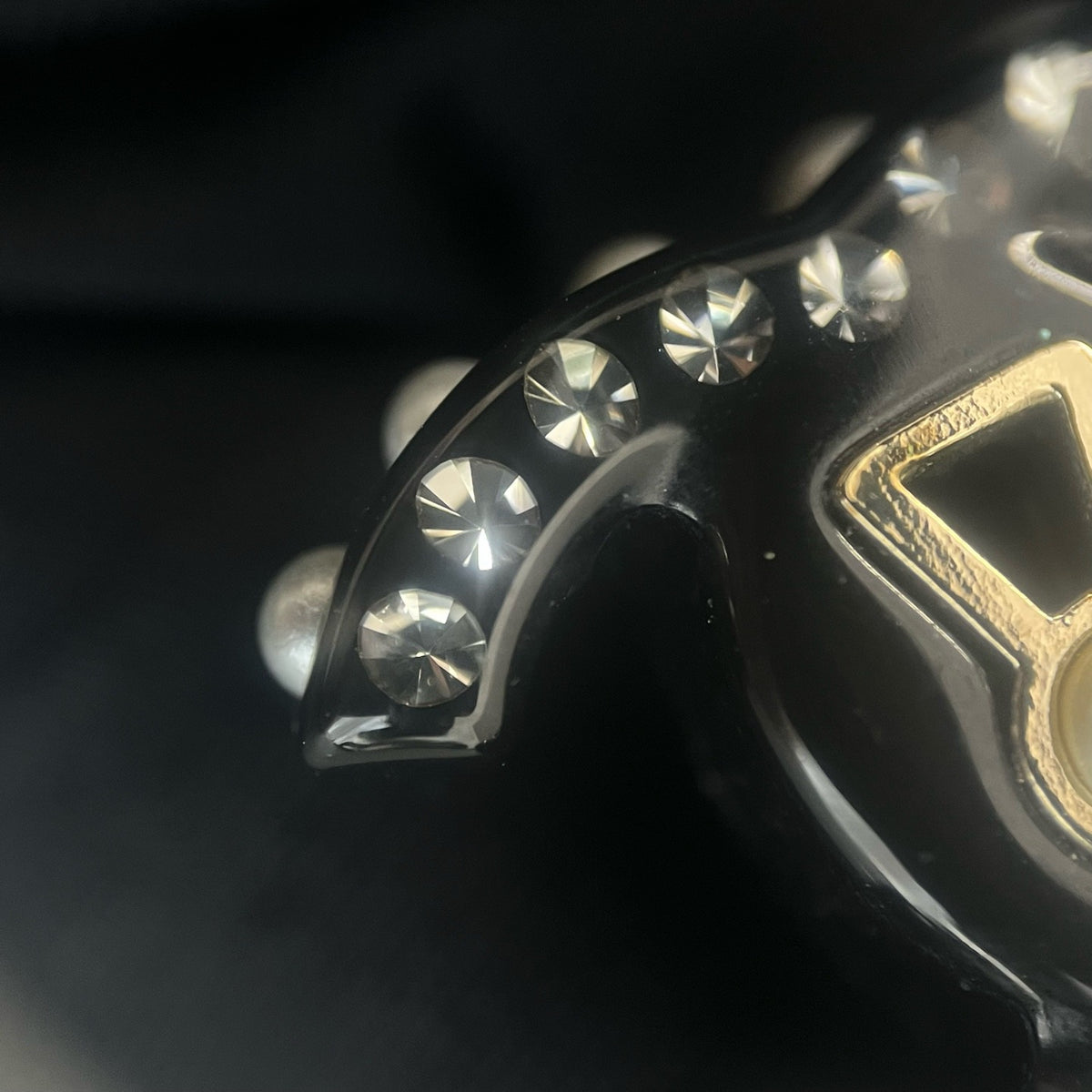 Chanel - Other - Gold-tone metal details with rhinestones, pearl and black resin elements; exact composition not confirmed. - Black