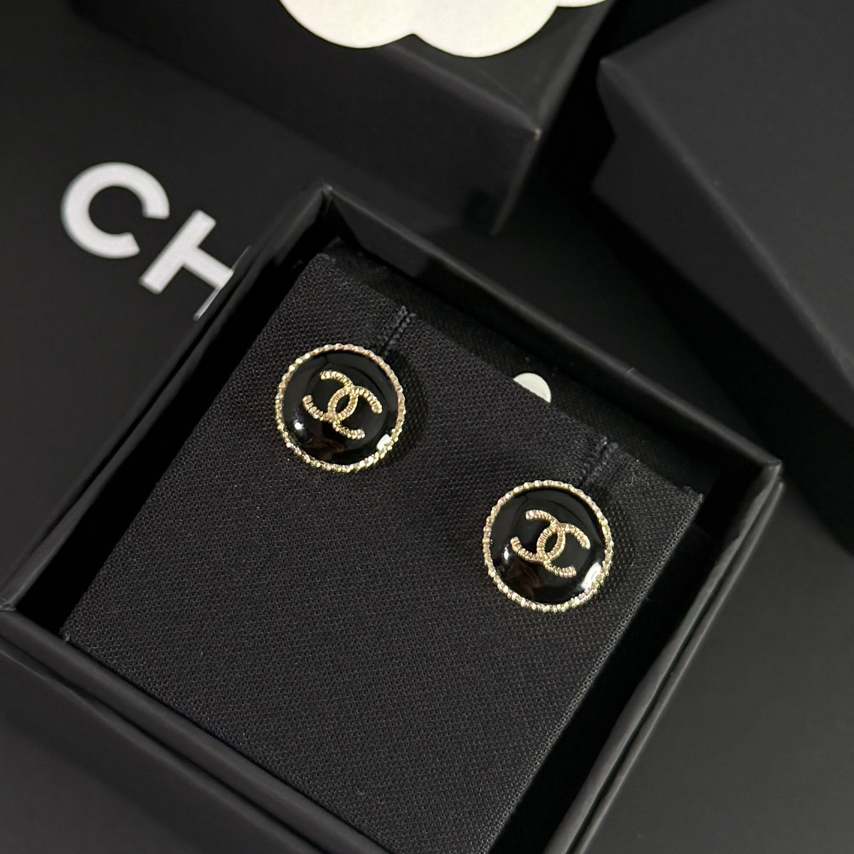 Chanel - Other - Gold-tone metal with a black enamel or resin centre; exact centre material is unconfirmed. - Black