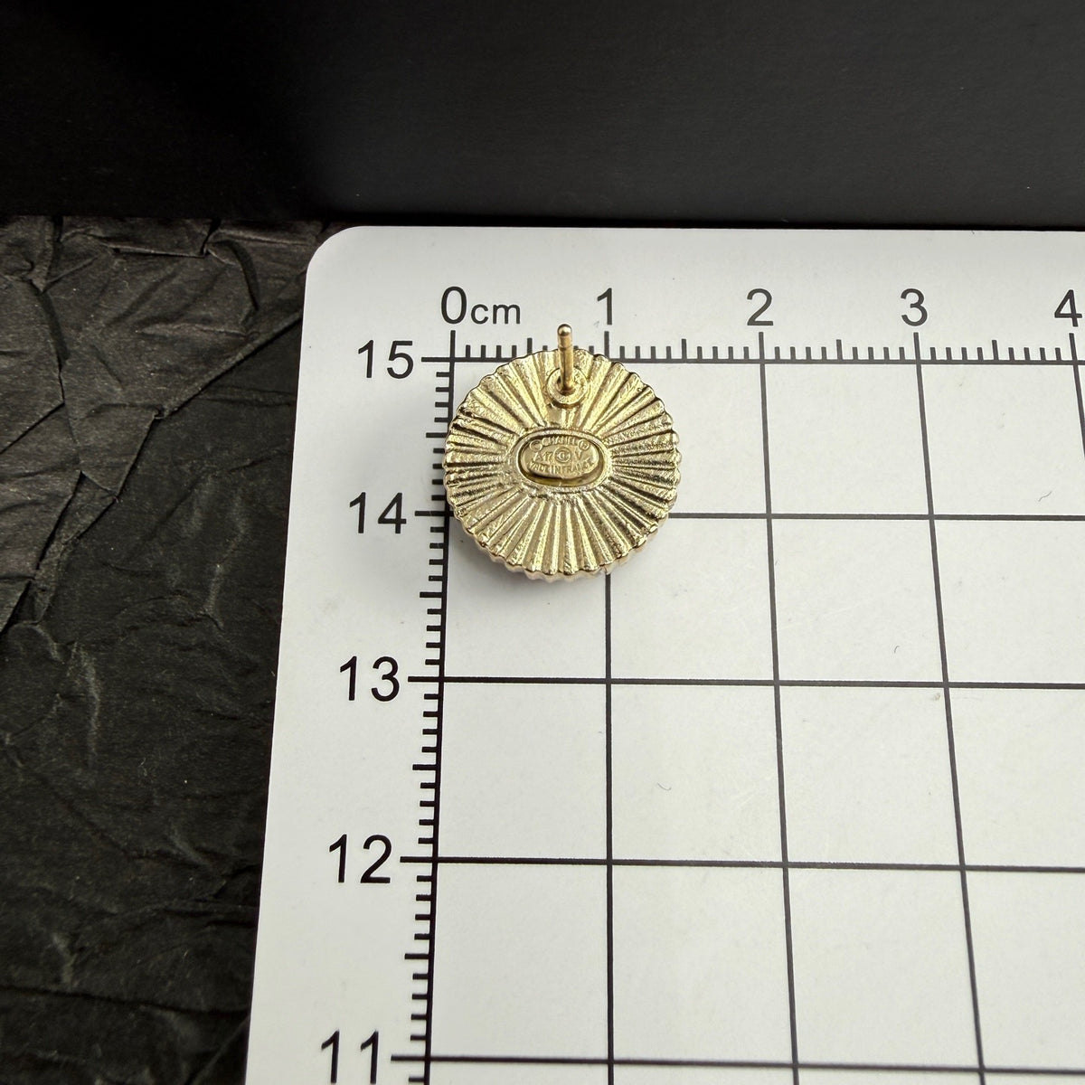 Chanel - Other - Gold-tone metal with a black enamel or resin centre; exact centre material is unconfirmed. - Black