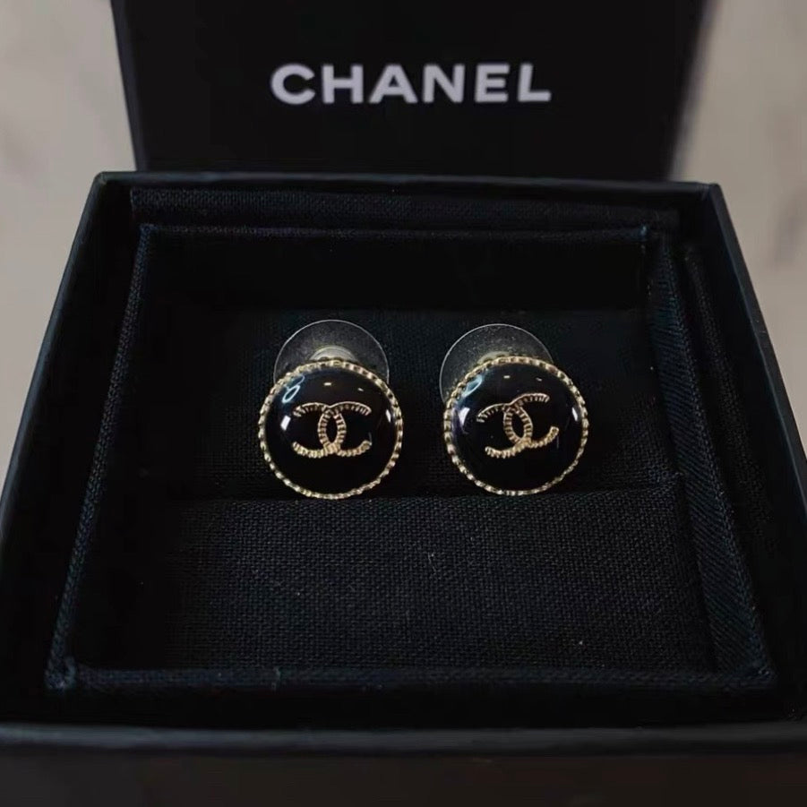 Chanel - Other - Gold-tone metal with a black enamel or resin centre; exact centre material is unconfirmed. - Black