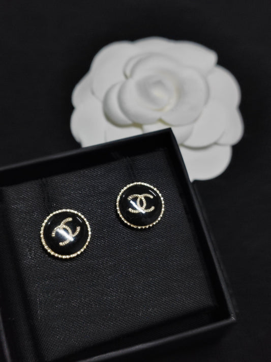 Chanel - Other - Gold-tone metal with a black resin-like front and rhinestone embellishments. - Black