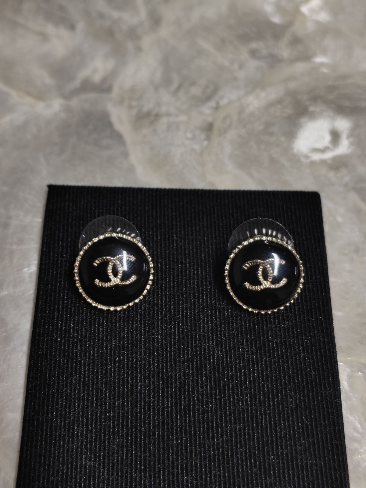 Chanel - Other - Gold-tone metal with a black resin-like front and rhinestone embellishments. - Black