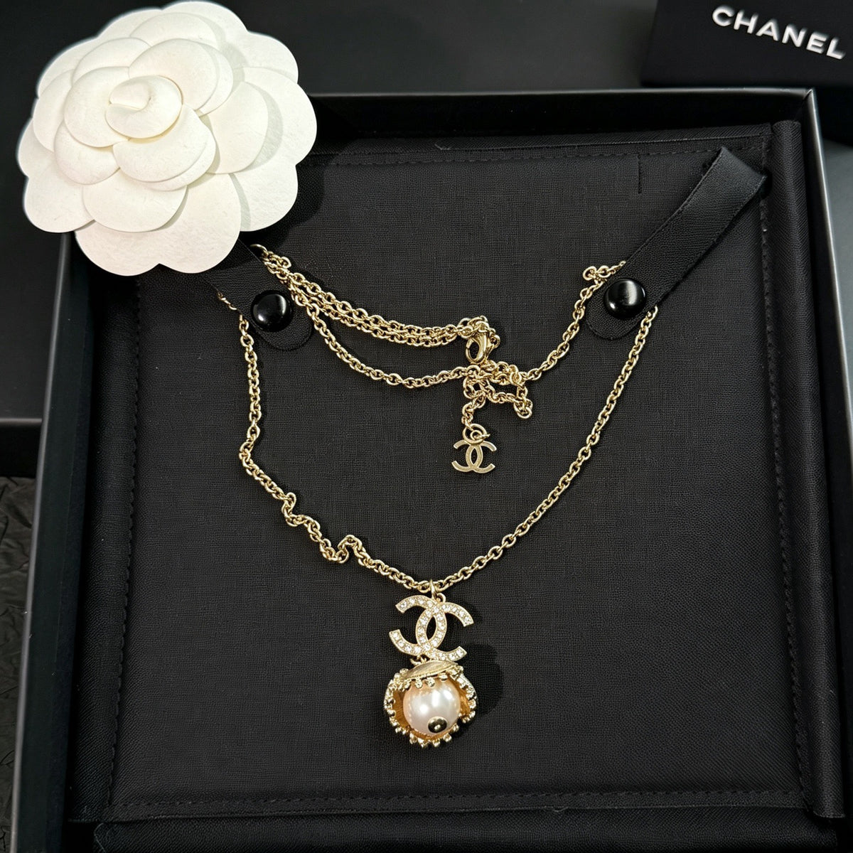 Chanel - Other - Gold-tone metal with a pearl-style pendant and clear decorative stones. - Gold