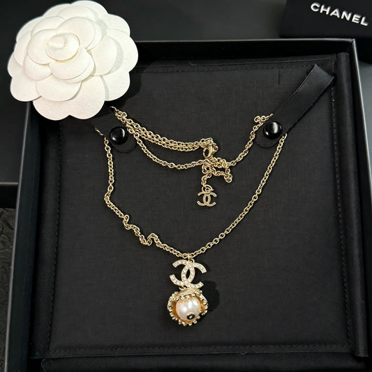 Chanel - Other - Gold-tone metal with a pearl-style pendant and clear decorative stones. - Gold