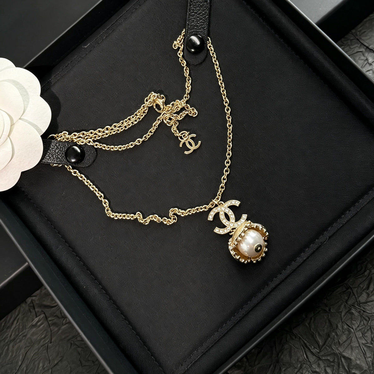 Chanel - Other - Gold-tone metal with a pearl-style pendant and clear decorative stones. - Gold